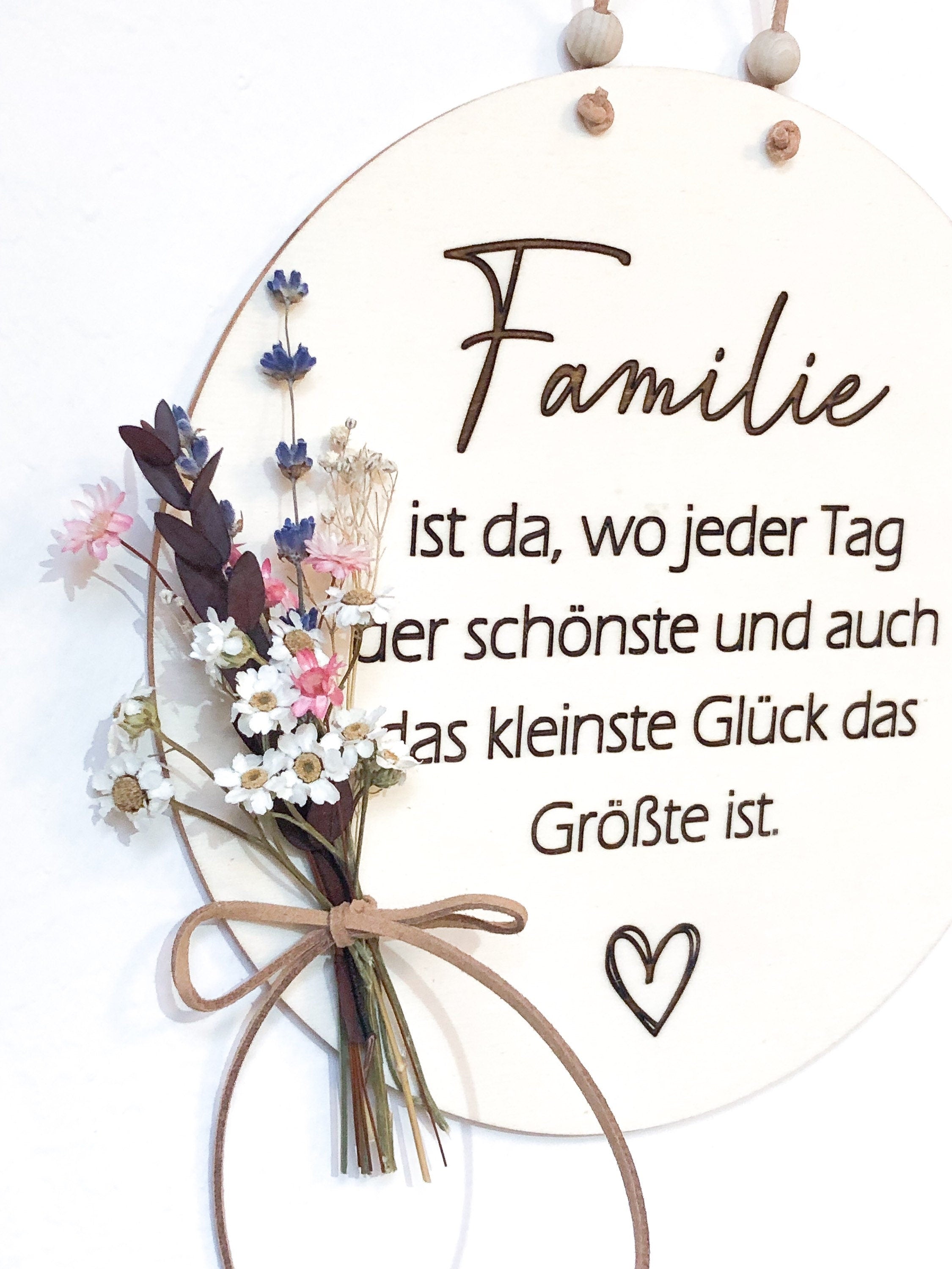 Wooden sign Family is where every day is the most beautiful and even the smallest happiness is the greatest with a bouquet of dried flowers