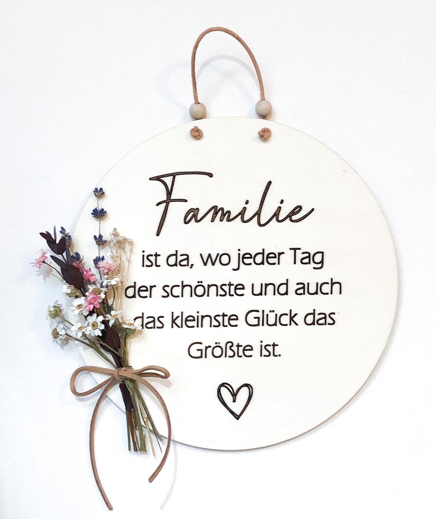 Wooden sign Family is where every day is the most beautiful and even the smallest happiness is the greatest with a bouquet of dried flowers